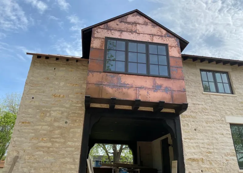 Copper metal panel facade on a stone building for Metal Roof Coating in Redding